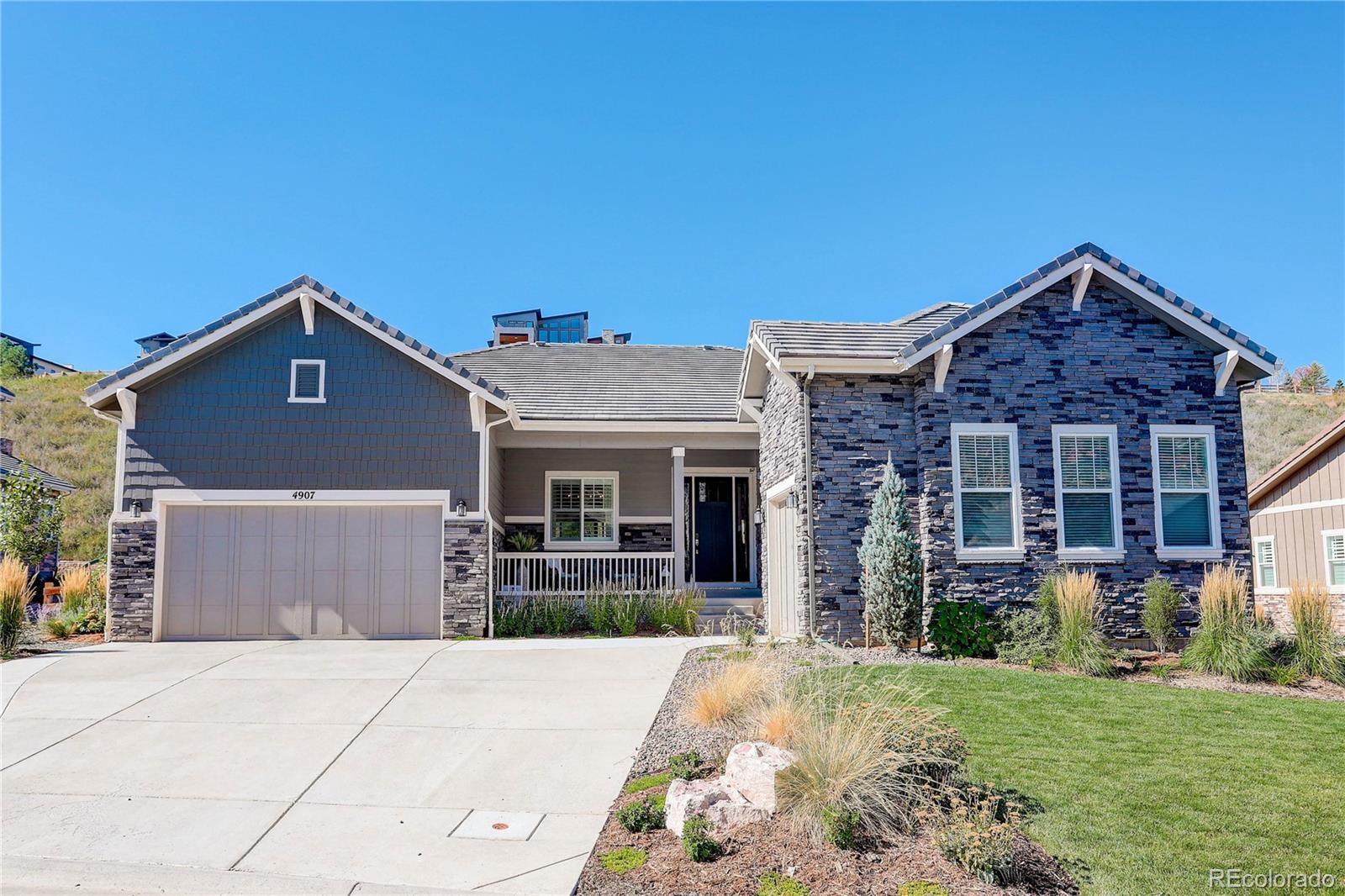 4907 Hogback Ridge Road Morrison, CO 80465 - Photo 1 of 47 front view of a house with a yard