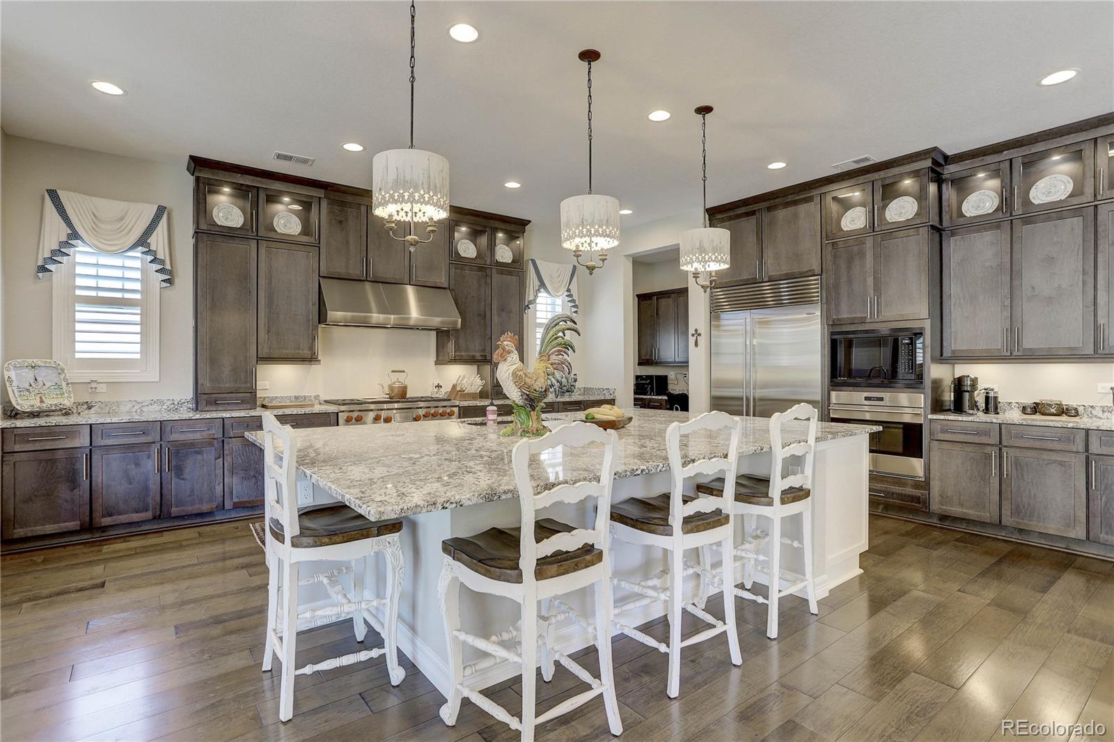 4907 Hogback Ridge Road Morrison, CO 80465 - Photo 11 of 47 a large kitchen with a table and chairs