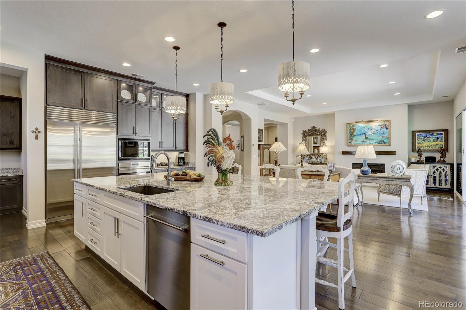 4907 Hogback Ridge Road Morrison, CO 80465 - Photo 12 of 47 a kitchen with stainless steel appliances granite countertop a sink a stove and a wooden floors