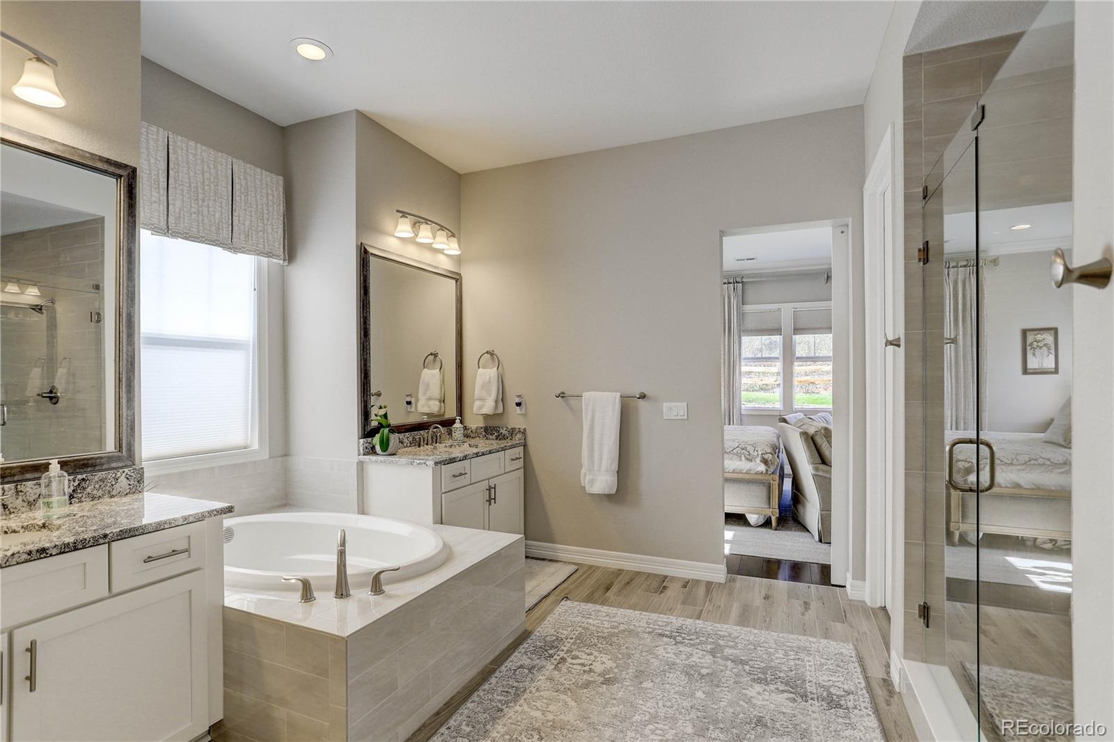 4907 Hogback Ridge Road Morrison, CO 80465 - Photo 21 of 47 a spacious bathroom with a granite countertop sink and a mirror