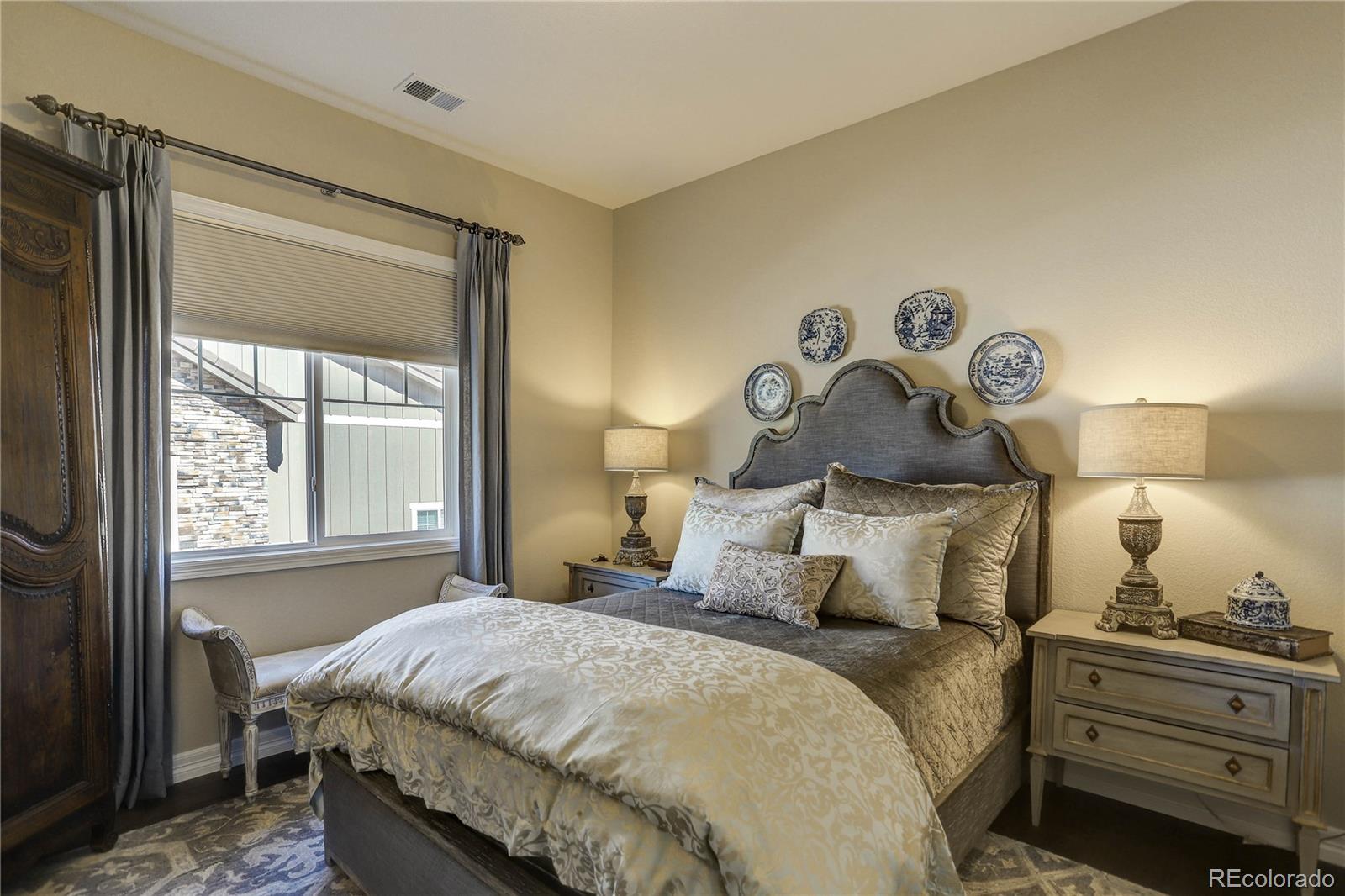 4907 Hogback Ridge Road Morrison, CO 80465 - Photo 25 of 47 a bedroom with a bed and a window