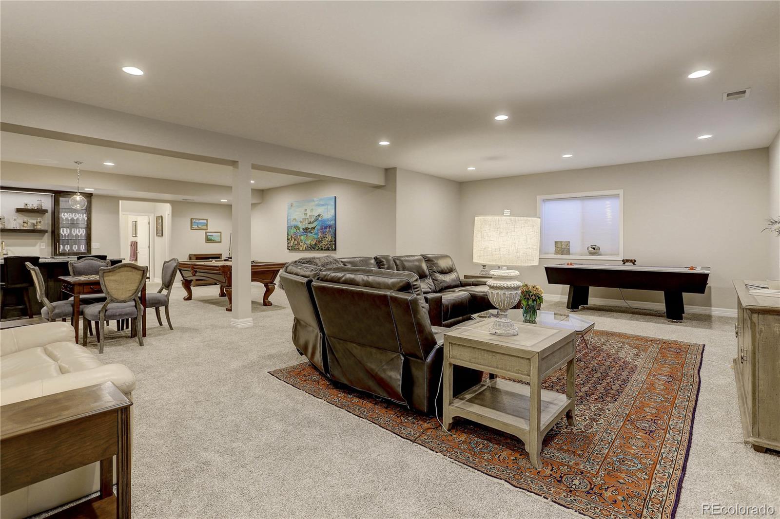 4907 Hogback Ridge Road Morrison, CO 80465 - Photo 31 of 47 a large kitchen with kitchen island a sink table and chairs