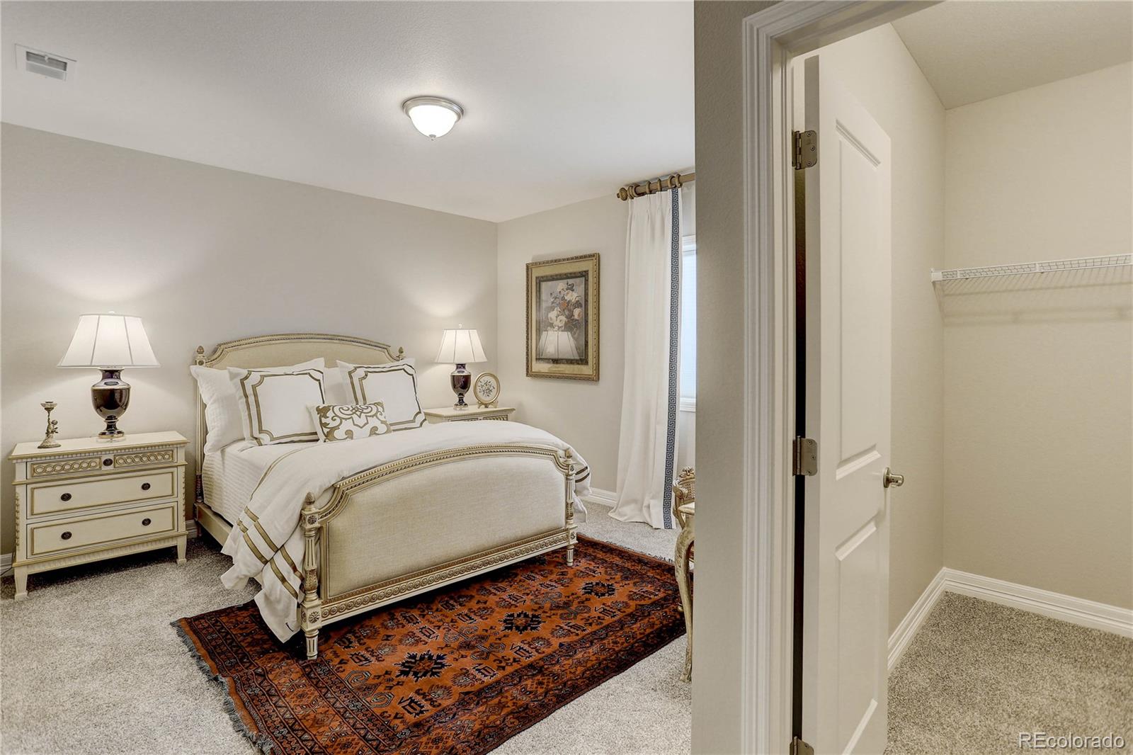 4907 Hogback Ridge Road Morrison, CO 80465 - Photo 37 of 47 a bedroom with a bed and a window