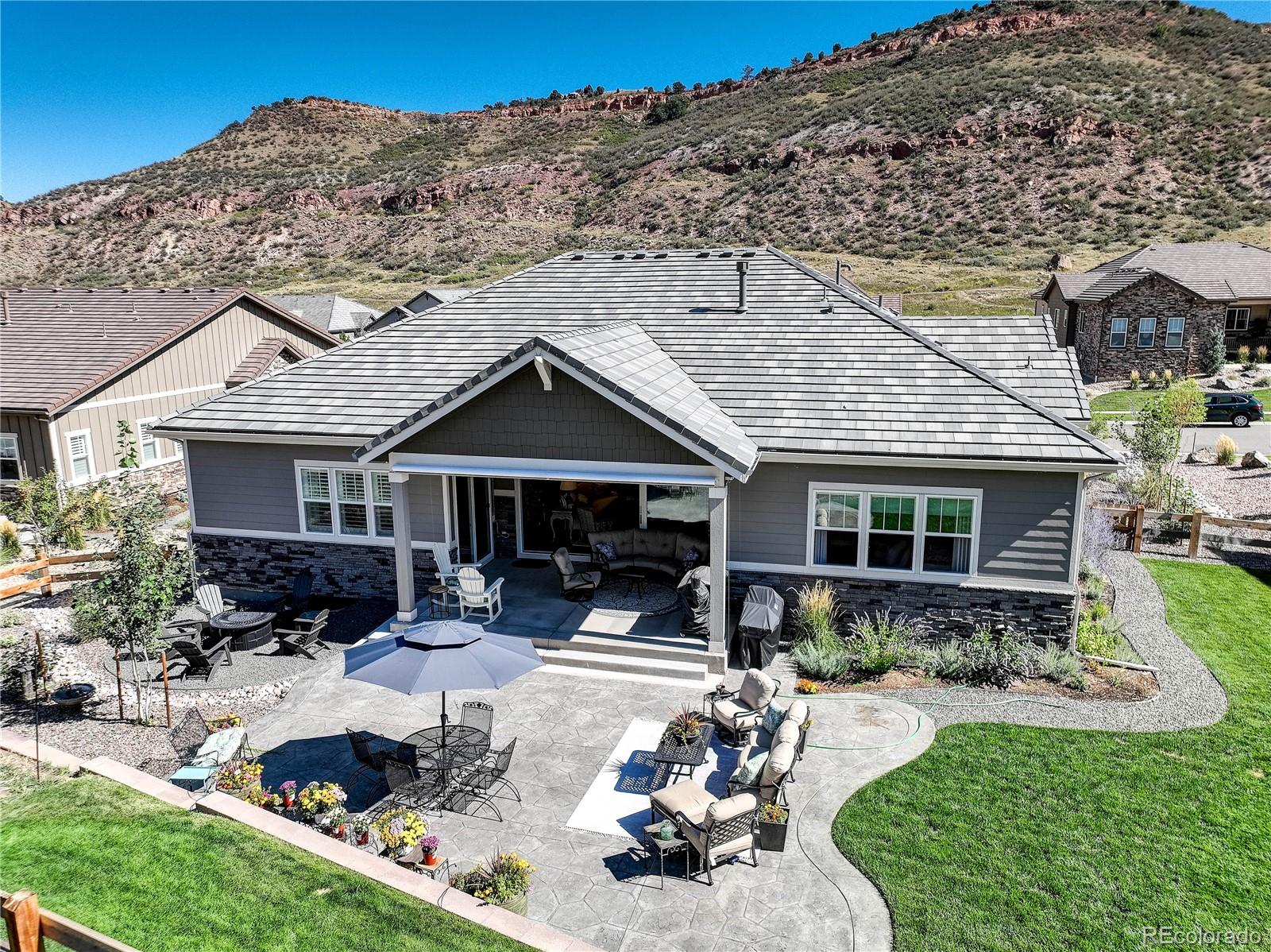 4907 Hogback Ridge Road Morrison, CO 80465 - Photo 40 of 47 a front view of a house with a yard outdoor seating and mountain view