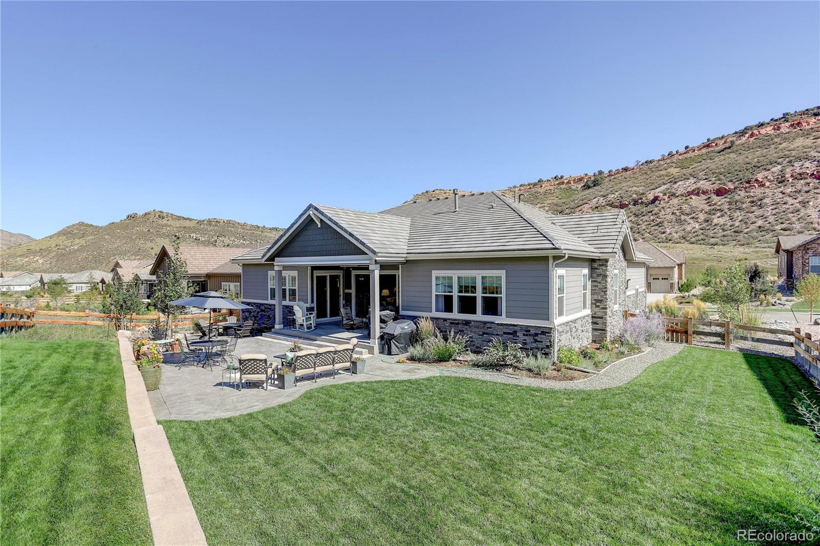 4907 Hogback Ridge Road Morrison, CO 80465 - Photo 42 of 47 a view of a house with patio outdoor seating