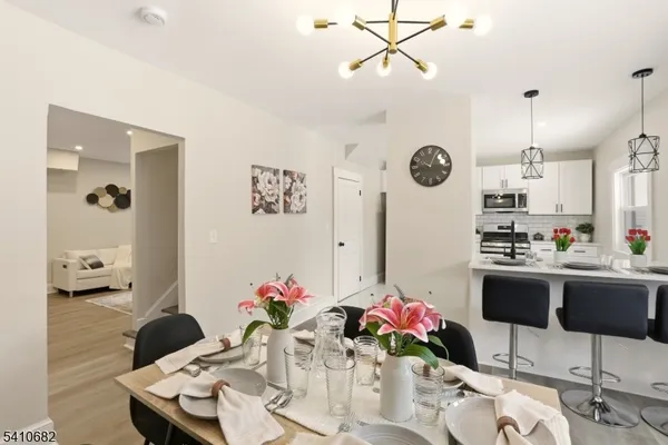 a kitchen with stainless steel appliances granite countertop white cabinets a refrigerator a stove a sink and a microwave