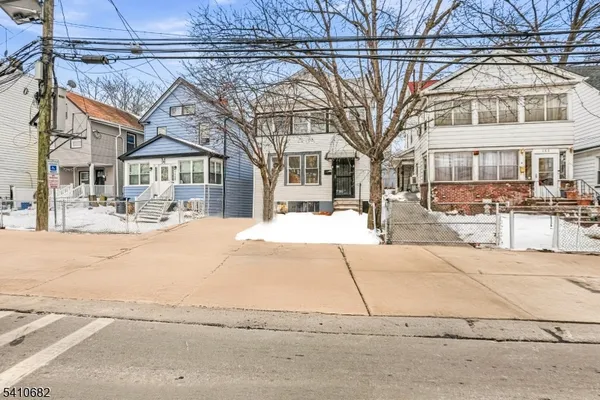 a front view of a residential apartment building with a yard