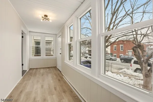 a view of room with furniture and wooden floor