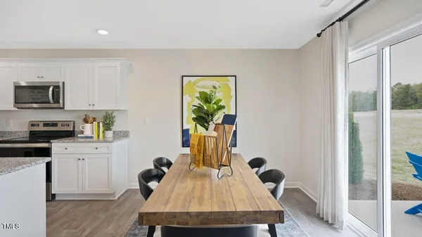 a view of kitchen with cabinets table and chairs