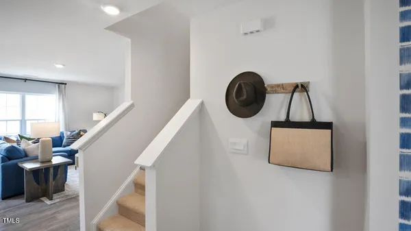 a view of entryway with furniture and wooden floor
