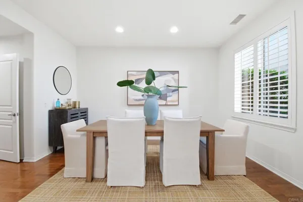 a living room with furniture a window and wooden floor