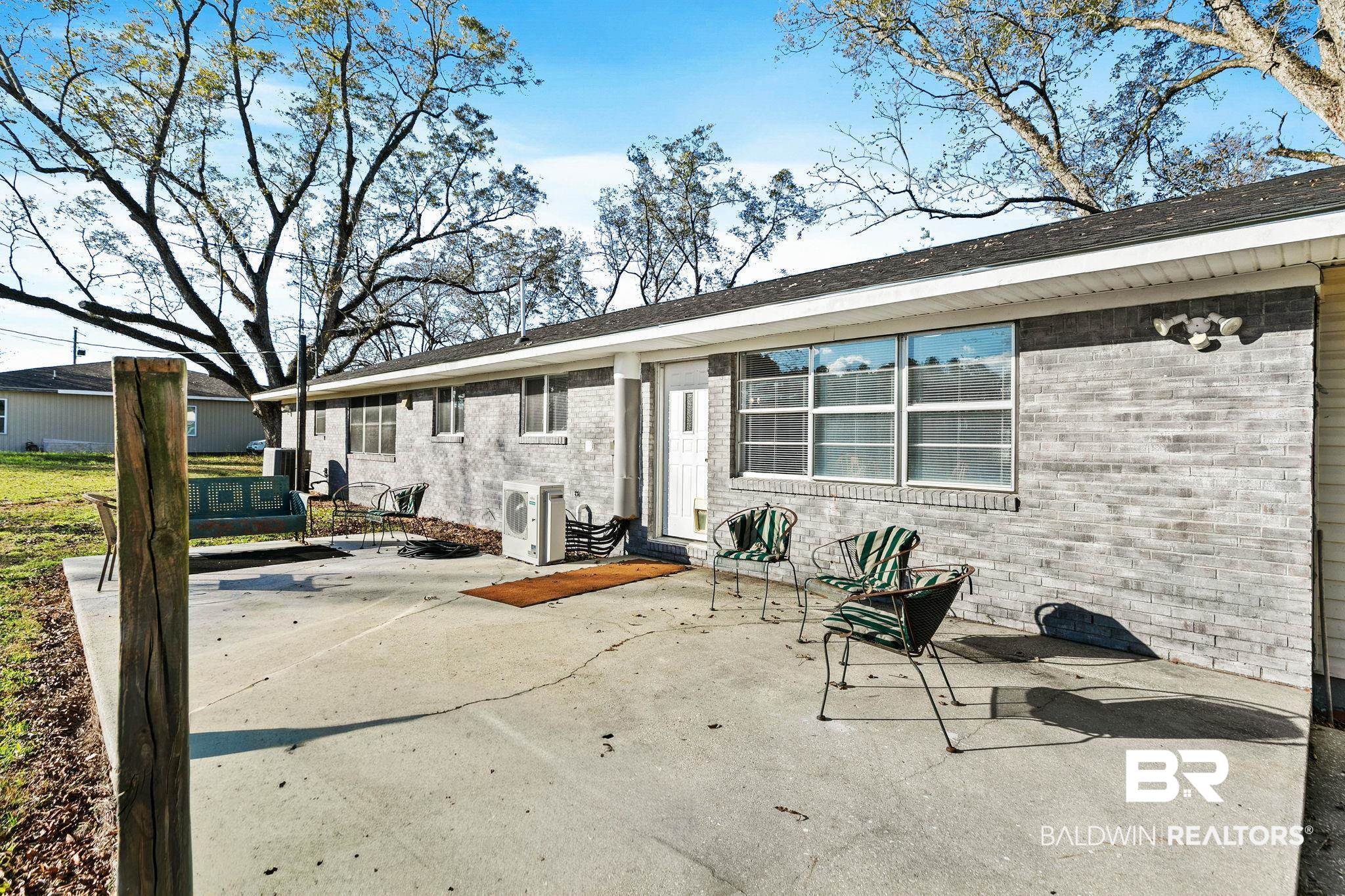 21267 Loop Road Andalusia, AL 36421 - Photo 56 of 72 Rear view of house with a patio area and brick siding