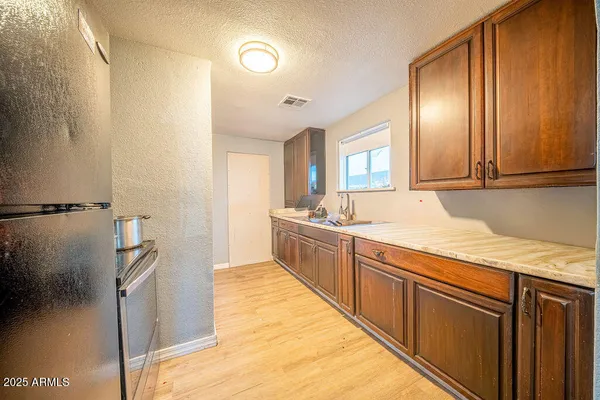a spacious bathroom with a granite countertop sink and a mirror