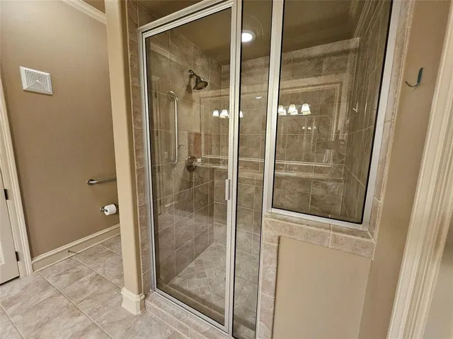 a bathroom with a glass shower door