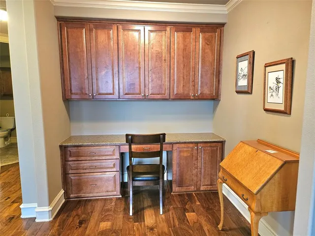 a room with a chair and next to a window