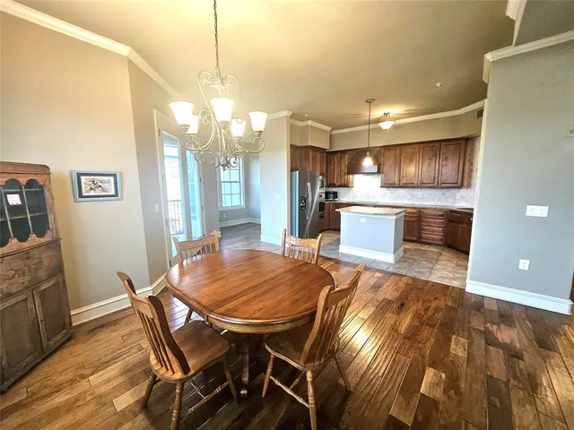 a kitchen with kitchen island a table and chairs in it