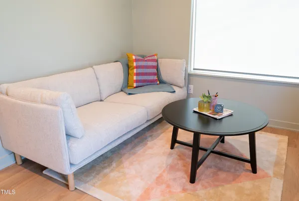 a living room with a couch and dining table