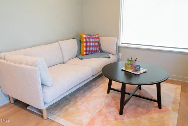 a living room with a couch and dining table