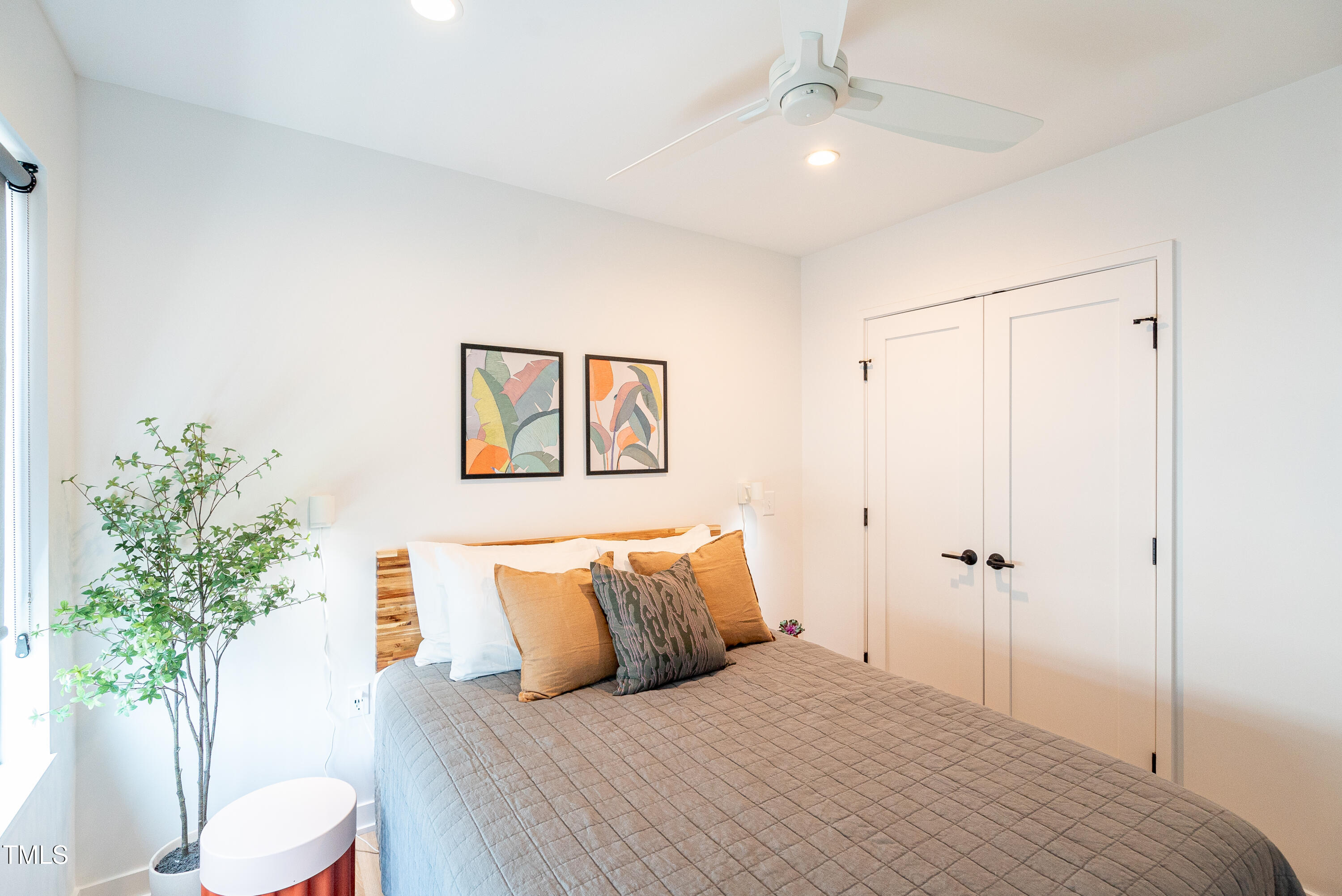 901 East Edenton Street, Unit 1 Raleigh, NC 27601 - Photo 8 of 17 a bedroom with a bed and a potted plant