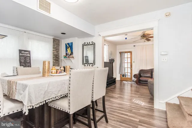 a dining room with furniture and wooden floor