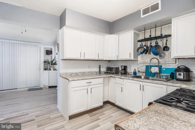 a kitchen with stainless steel appliances granite countertop a sink and cabinets