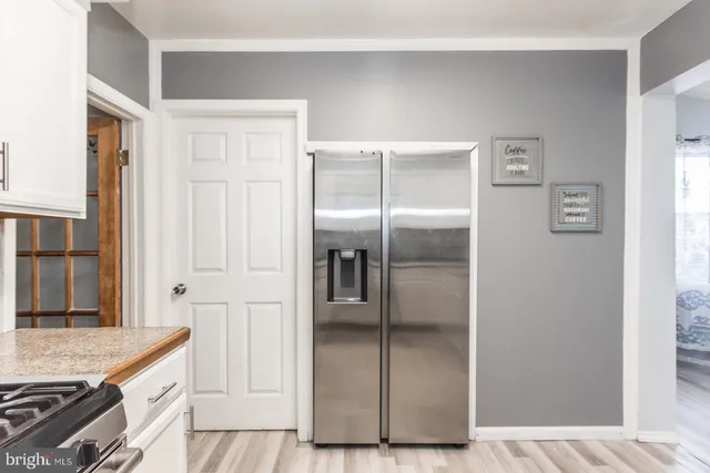 a kitchen with granite countertop a refrigerator and a stove