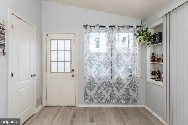 a bathroom with a shower curtain and a window