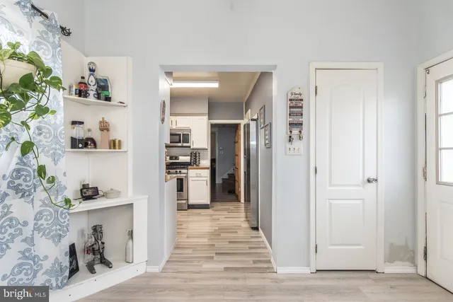 a view of a kitchen and an empty room