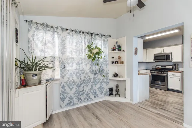 a kitchen with a refrigerator and a stove top oven