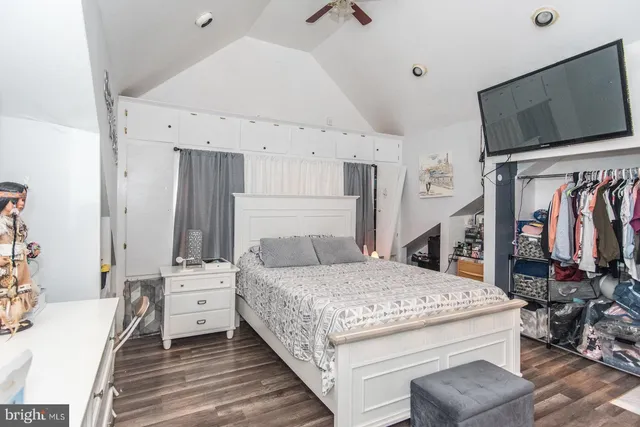 a bedroom with bed and a flat tv screen