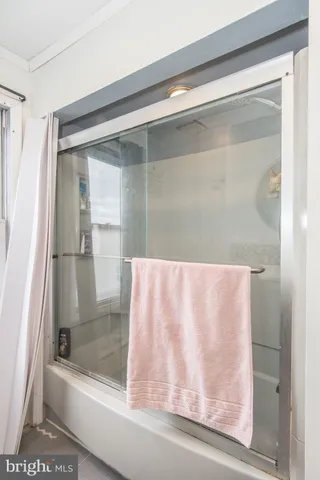 a bathroom with bathtub and shower