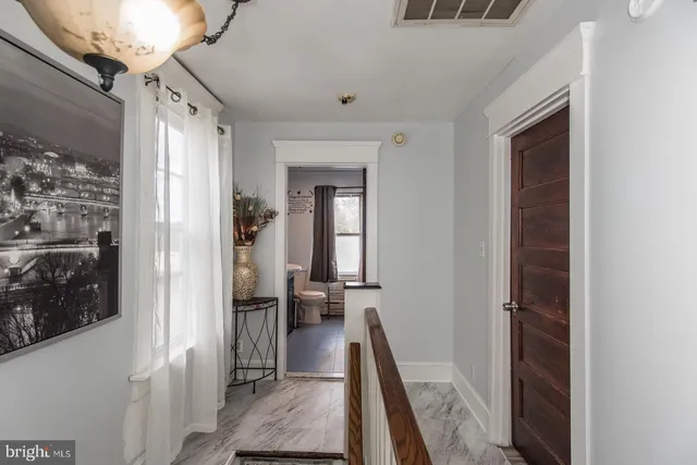 a view of a bathroom from a hallway