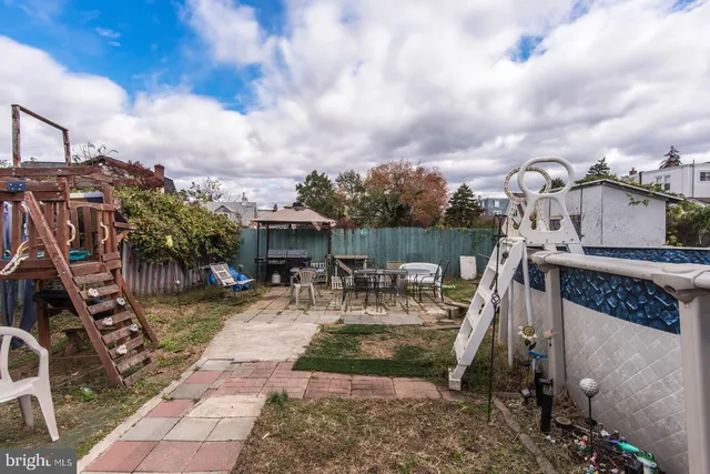 a view of a house with backyard water fountain and sitting area