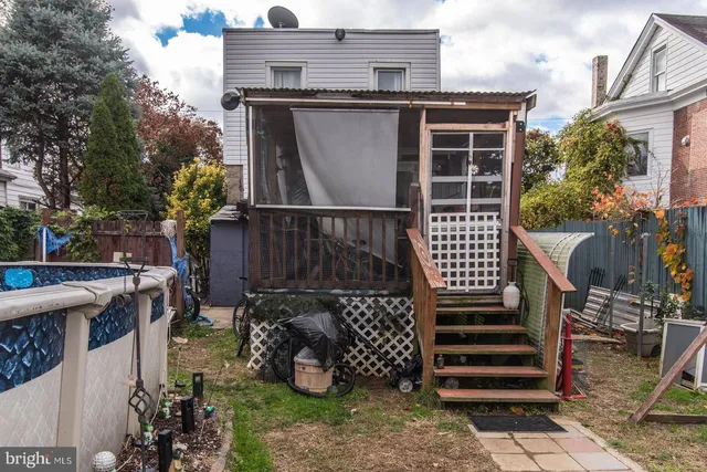 a view of a patio with table and chairs a barbeque with wooden fence