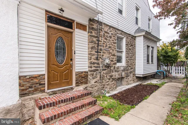 a view of a house with door and wooden fence