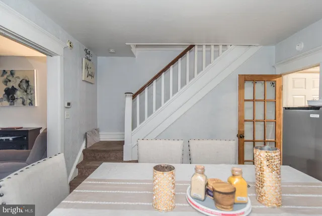 a living room with wooden floor and furniture