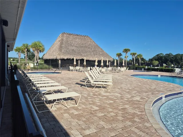 swimming pool view with a seating space and a garden view