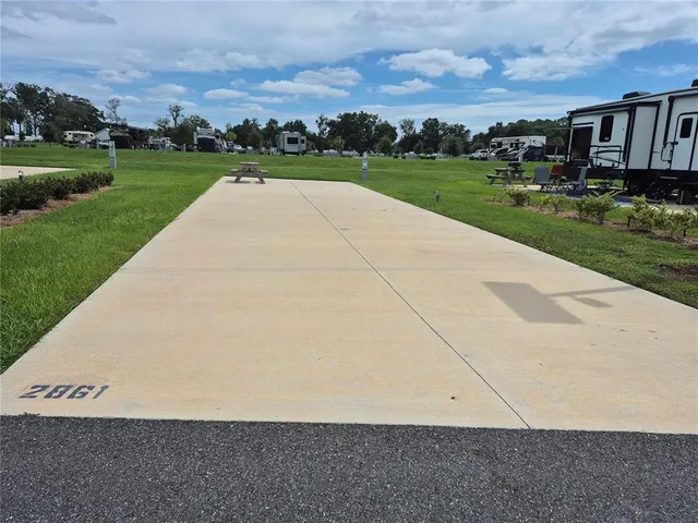 an aerial view of a house with yard and mountain view in back