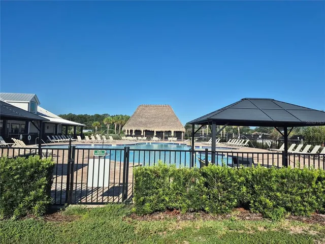 a view of a garden with a deck and a yard
