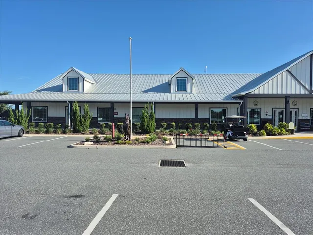 a view of the patio with dining table and chairs under an umbrella