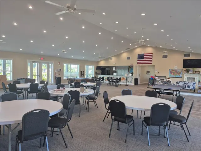 a large kitchen with a table and chairs