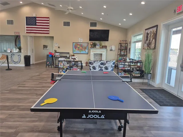 a room with furniture pool table and windows