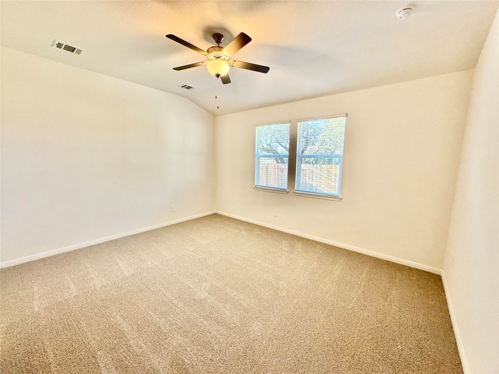 1764 South Main Street Kyle, TX 78640 - Photo 3 of 7 an empty room with a window and a chandelier
