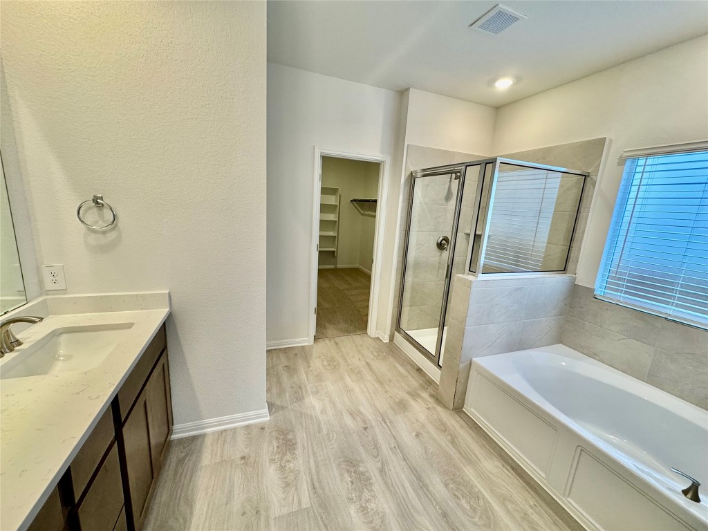 1764 South Main Street Kyle, TX 78640 - Photo 4 of 7 a bathroom with a sink and a mirror