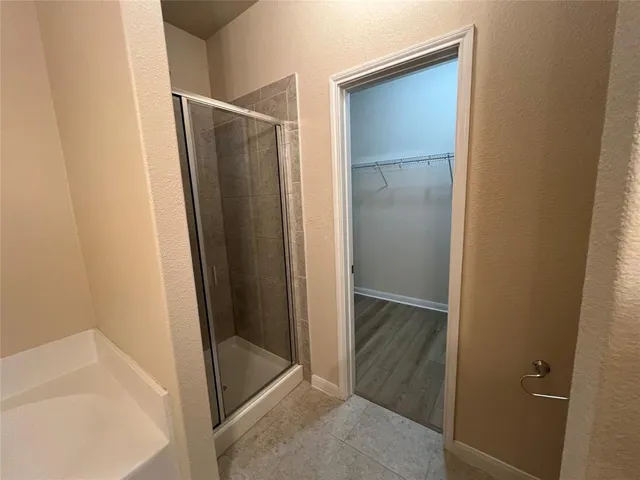 a bathroom with a tub and shower