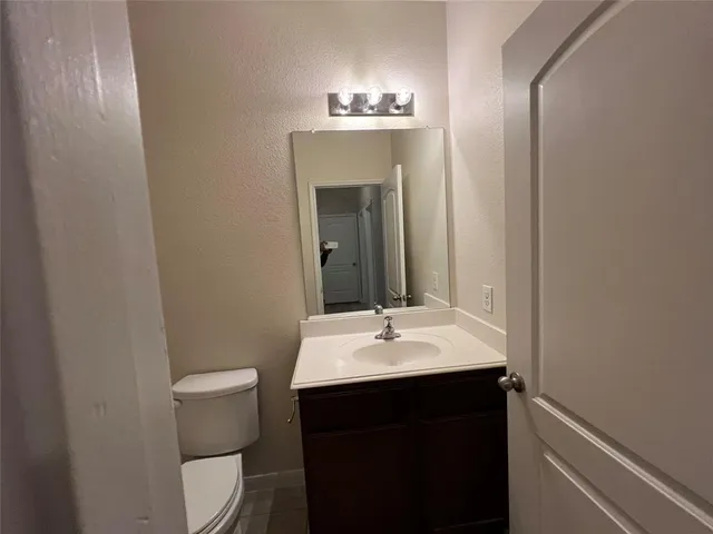a bathroom with a sink and a mirror with toilet