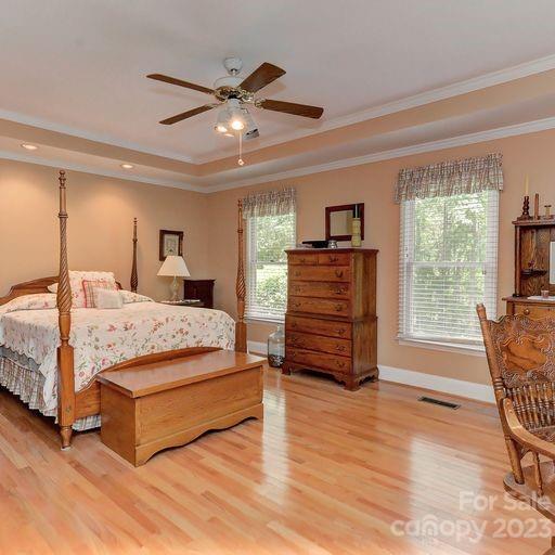 900 Woodland Forest Road Marvin, NC 28173 - Photo 18 of 36 a bedroom with a bed and wooden floor