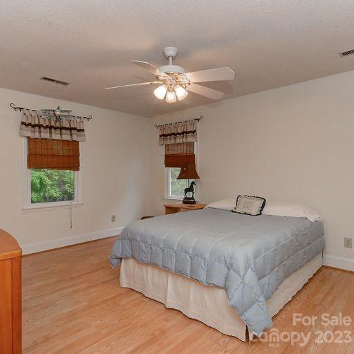 900 Woodland Forest Road Marvin, NC 28173 - Photo 24 of 36 a bedroom with a bed and a chandelier