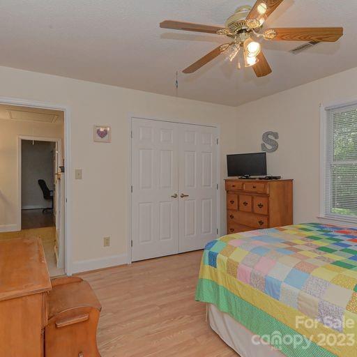 900 Woodland Forest Road Marvin, NC 28173 - Photo 25 of 36 a bedroom with a bed and a chandelier