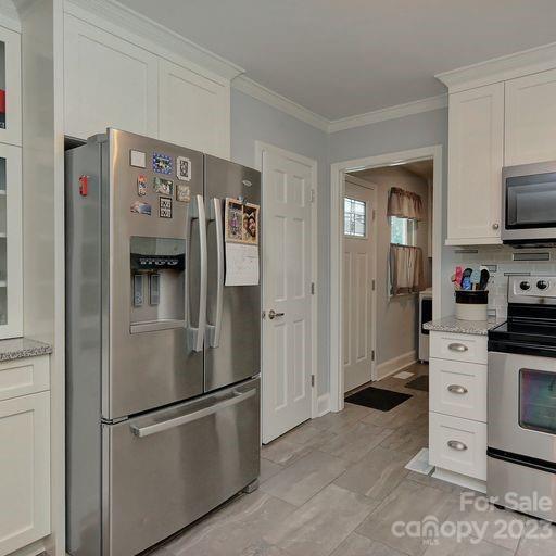 900 Woodland Forest Road Marvin, NC 28173 - Photo 10 of 36 a kitchen with stainless steel appliances a refrigerator stove and sink